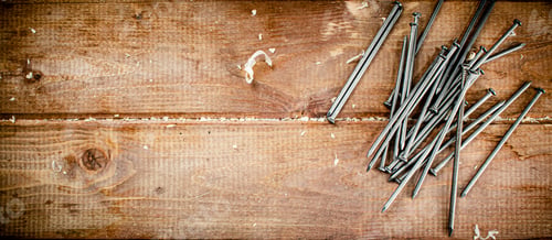 Preview: Nails on the table. On a wooden background.