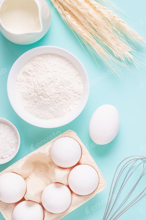 Preview: Ingredients for baking on light blue background.