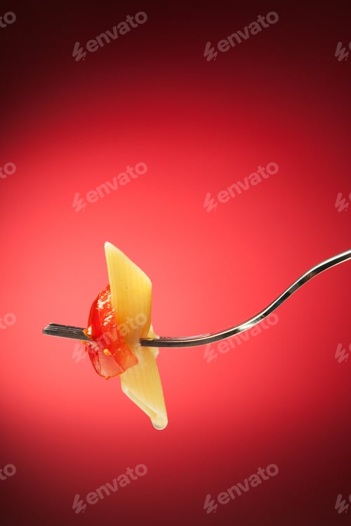 Preview: Fork with pasta and tomato on a red background