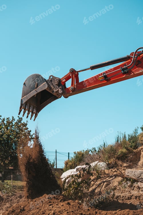 Preview: Closeup of a backhoe with dirt against sky