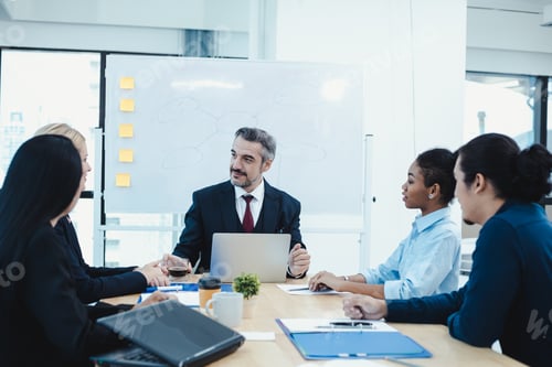Preview: Business team and manager in meeting room.