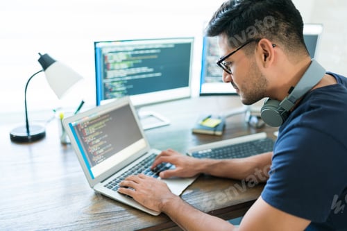 Preview: Handsome Young Male Programmer Coding On Laptop