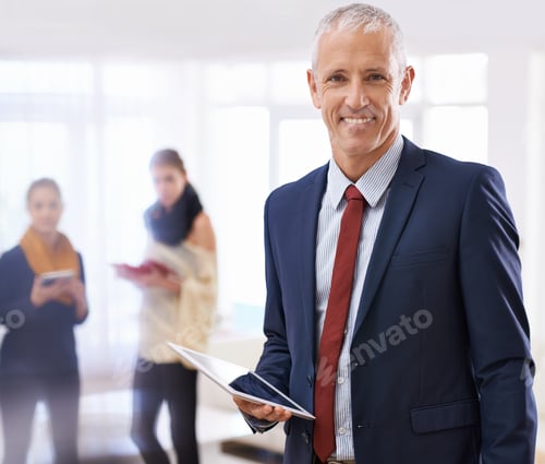Preview: Shot of a mature businessman standing in the foreground with two colleagues behind him