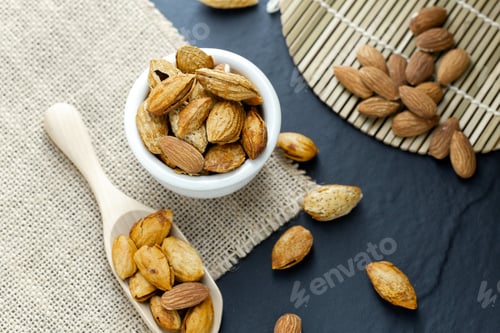 Preview: Almonds in a black bowl against dark rustic wooden background