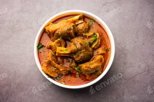 Bowl of Meat Curry Garnished with Herbs