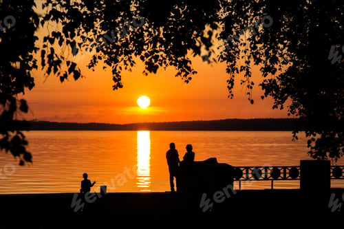 Preview: Silhouette of a couple in love at sunset or sunrise