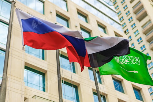 Preview: United Arab Emirates and Russia flag waving against building