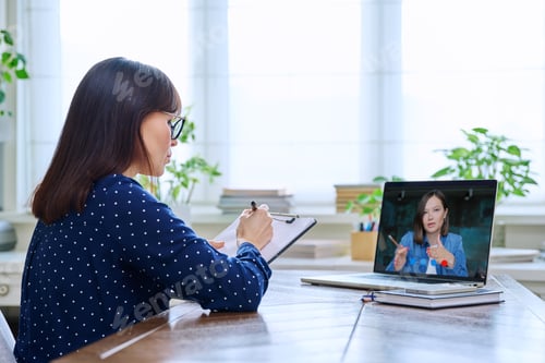 Preview: Mature woman talking online with young female using video call