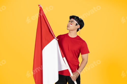 Preview: Side view of Indonesian man holding red and white flag as his country's flag