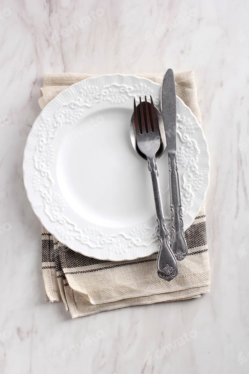 Preview: White Plate with Spoon, Fork, and Knife. Copy Space