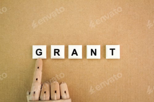 Preview: wooden hand with the word grant alphabet letters