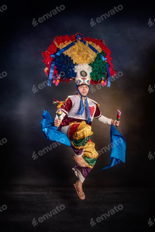 Preview: Oaxaca Feather Dancer, Guelaguetza Mexico A man in a colorful costume is jumping in the air