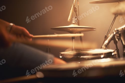 Preview: Cropped image of a talented drummer hitting his drum skins hard at a gig