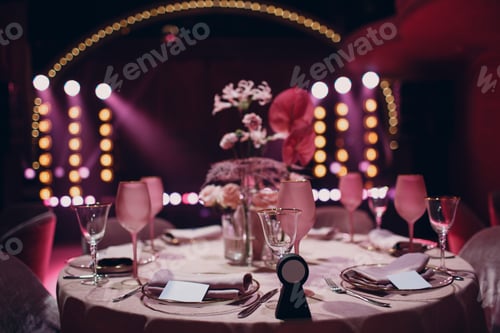 Preview: Romantic dinner pink decor table at restaurant with stage