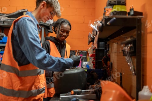Preview: Young Mechanics Working Together in a Workshop,
