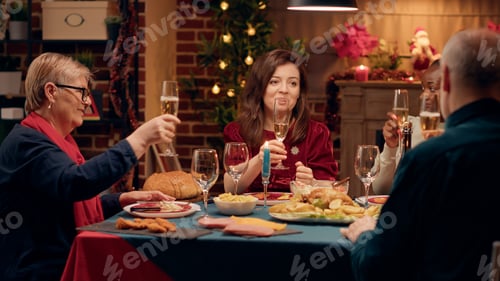 Preview: Happy close relatives clinking sparkling wine while celebrating winter feast together