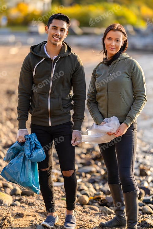 Preview: Young multi-ethnic team of environmental volunteers standing at beach