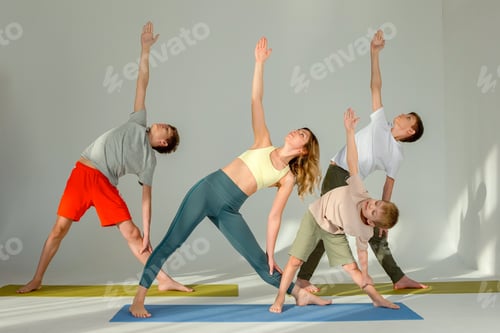 Preview: Sports family, slim woman, boy and two teenagers stand in yoga pose in sunny studio.