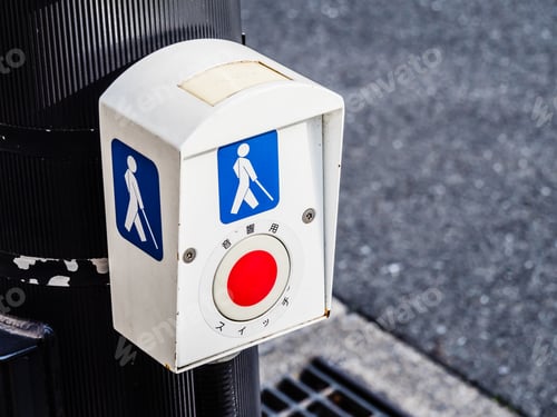 Preview: Closeup shot of an accessibility sidewalk crossing button for blind people