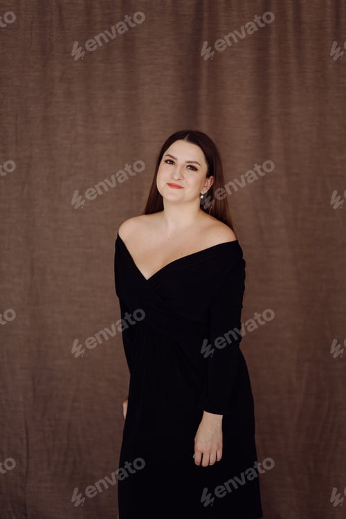 Preview: Elegant Woman in Black Dress Posing Indoors