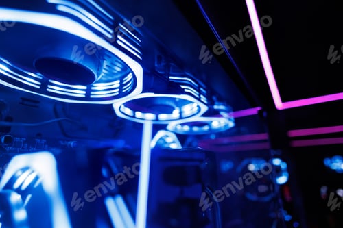 Preview: Professional gaming computer with neon backlight with headset in the computer club for gamers.