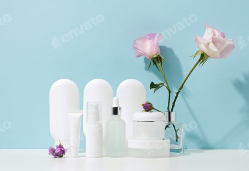 Preview: Empty white plastic tubes and jars for cosmetics. Packaging for cream