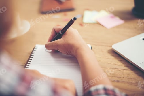 Preview: Young hipster woman writing and work in workplace.