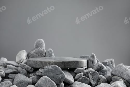 Preview: Presentation for product. Stone and pebbles on grey background. Space for text