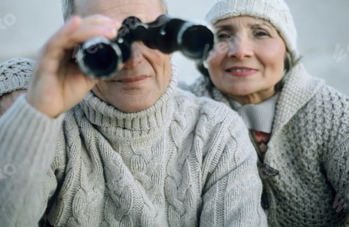 Preview: A couple enjoying a day outdoors with binoculars