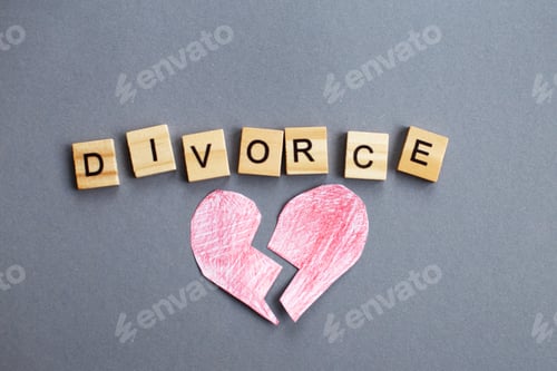 Preview: broken heart on gray background and inscription divorce made by wooden blocks. broken family concept