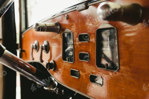 Preview: Valencia, Spain - December 8, 2018: Wooden dashboard of an old vintage car.