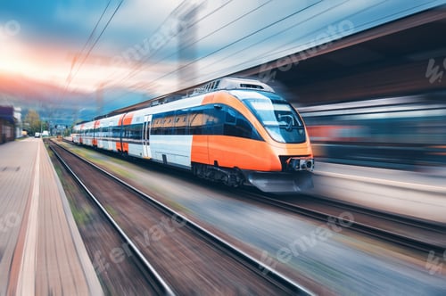 Preview: High speed orange train in motion on the railway station