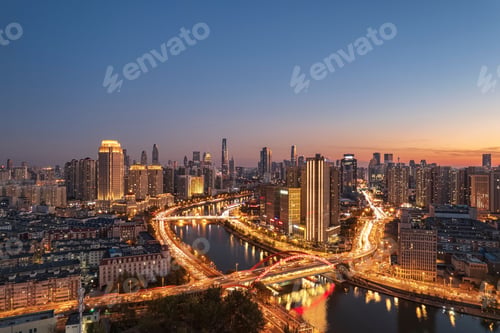 Preview: Aerial shot of an urban skyline with landmarks along the Haihe River in Tianjin, China at sunset