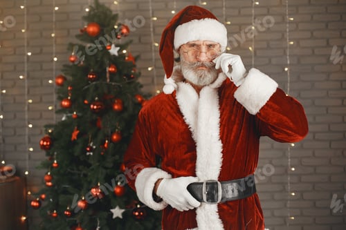 Preview: Man in santa claus costume looking at the camera