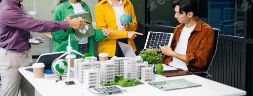 Preview: Group of diverse multiethnic businesspeople standing neare table looking at model of building from