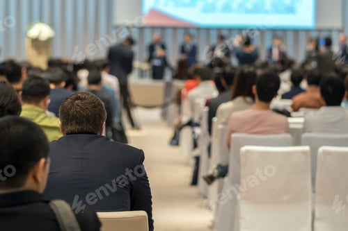 Preview: Speakers on the stage with Rear view of Audience in the conference hall or seminar meeting