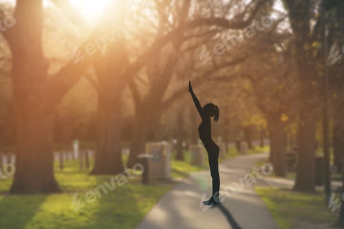Preview: Silhouette Young Woman Practicing Yoga On Public Park At Sunset.
