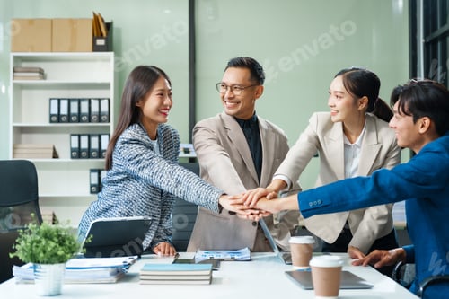 Preview: In a boardroom, an Asian team meets at a desk, presenting financial terms and strategies.