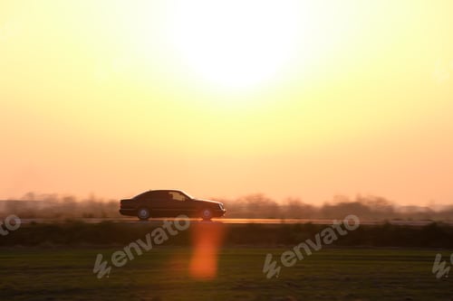 Preview: Car driving fast on intercity road at sunset. Highway traffic in evening