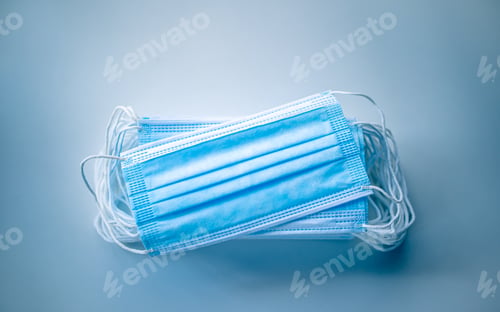 Preview: Stack of Disposable Face Masks on Blue Background
