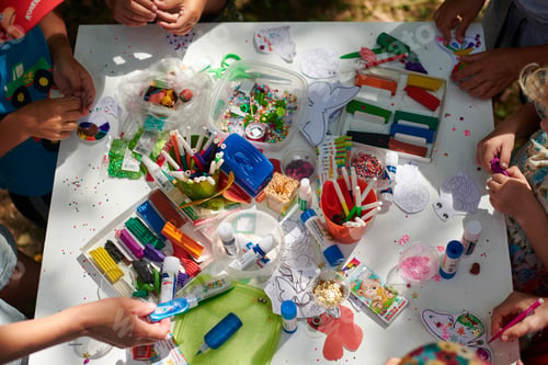 Preview: Children paper crafting with parents in outdoor children party, painting, molding of plasticine