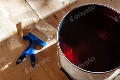 Preview: Varnish can and brushes on wooden floor in empty room