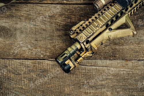 Preview: Close up photo of M16 rifle on wooden board