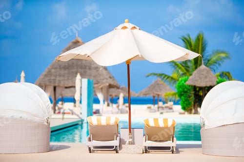 Preview: Sunbeds and umbrella at beautiful tropical resort