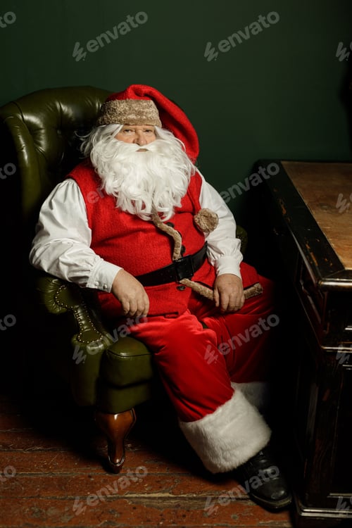 Preview: Santa relaxing in armchair by vintage desk with copy space for holiday ads