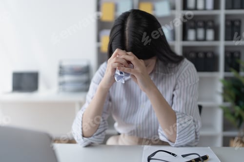 Preview: businesswoman plans a finance audit, reviewing documents while battling burnout syndrome.