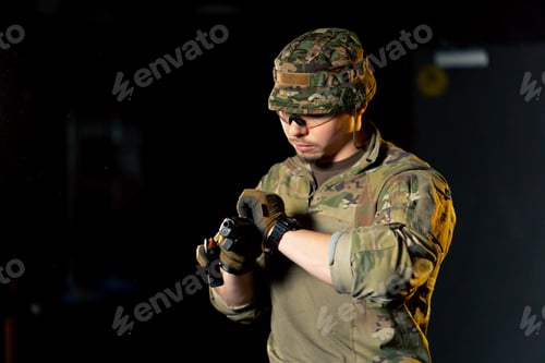 Preview: close-up at a professional shooting range a military trainer reloading a pistol ready to shoot