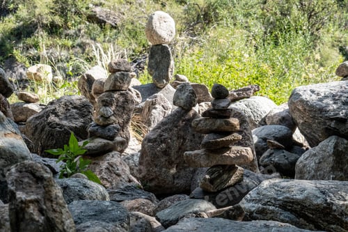 Preview: Closeup image of rocks delicately balanced against each other in a precarious position