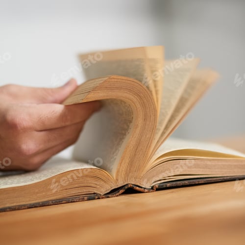 Preview: Old school stories. Cropped shot of an unidentifiable man reading a book.