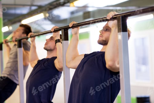Preview: group of young men doing pull-ups in gym